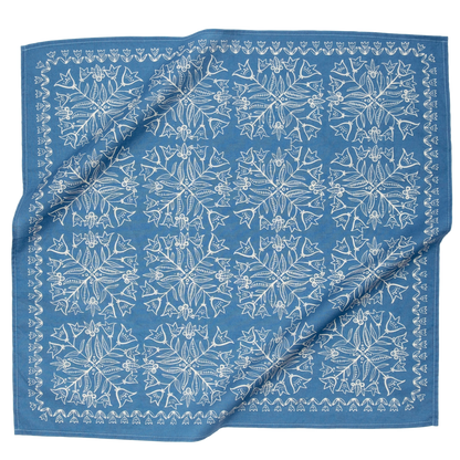This image features a **square fabric bandana** with a **white symmetrical floral and botanical pattern** on a soft blue background. The intricate design consists of repeating motifs, including delicate leaves, flowers, and small decorative elements, creating a vintage or folk-art-inspired look. A decorative border frames the edges, enhancing its classic appeal. The fabric appears lightweight and breathable, making it a versatile accessory for wearing as a headband, neck scarf, or decorative accent.