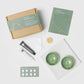 Kintsugi repair kit with green ceramic bowls and repair materials on a white background
