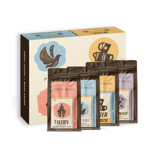 Press House Coffee sampler box with four coffee bags—Tavern, Early Bird, Better, and Rebel Roast—lined up in front of the box.