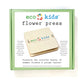 The Eco-Kids flower press kit, shown in its green box, includes tools to press and preserve flowers and leaves. It helps kids save the beauty of summer blooms and autumn foliage in a fun, hands-on way.