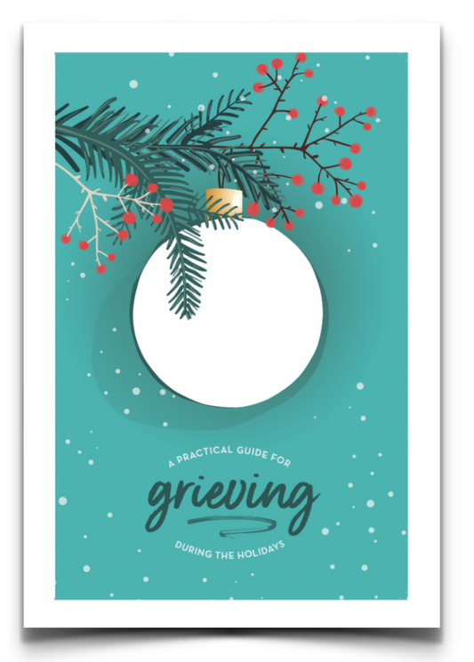 This image features the cover of a booklet titled **"A Practical Guide for Grieving During the Holidays."** The design includes a **winter holiday theme**, with a **teal background**, **snowfall effect**, and an illustration of a **white ornament hanging from pine branches with red berries**. The typography combines a mix of elegant script and clean, modern text, emphasizing the word grieving."

The cover suggests that the booklet provides support and guidance for coping with grief during the holidays.