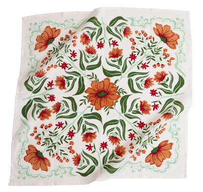This image features a **square fabric bandana** with a **vibrant floral pattern**. The design includes **large orange flowers, smaller red blossoms, and lush green leaves**, all arranged symmetrically on a white background. Delicate mint-green decorative elements frame the edges, enhancing the overall intricate and organic aesthetic. The fabric appears lightweight, making it a versatile accessory for wearing as a headband, scarf, or decorative piece.