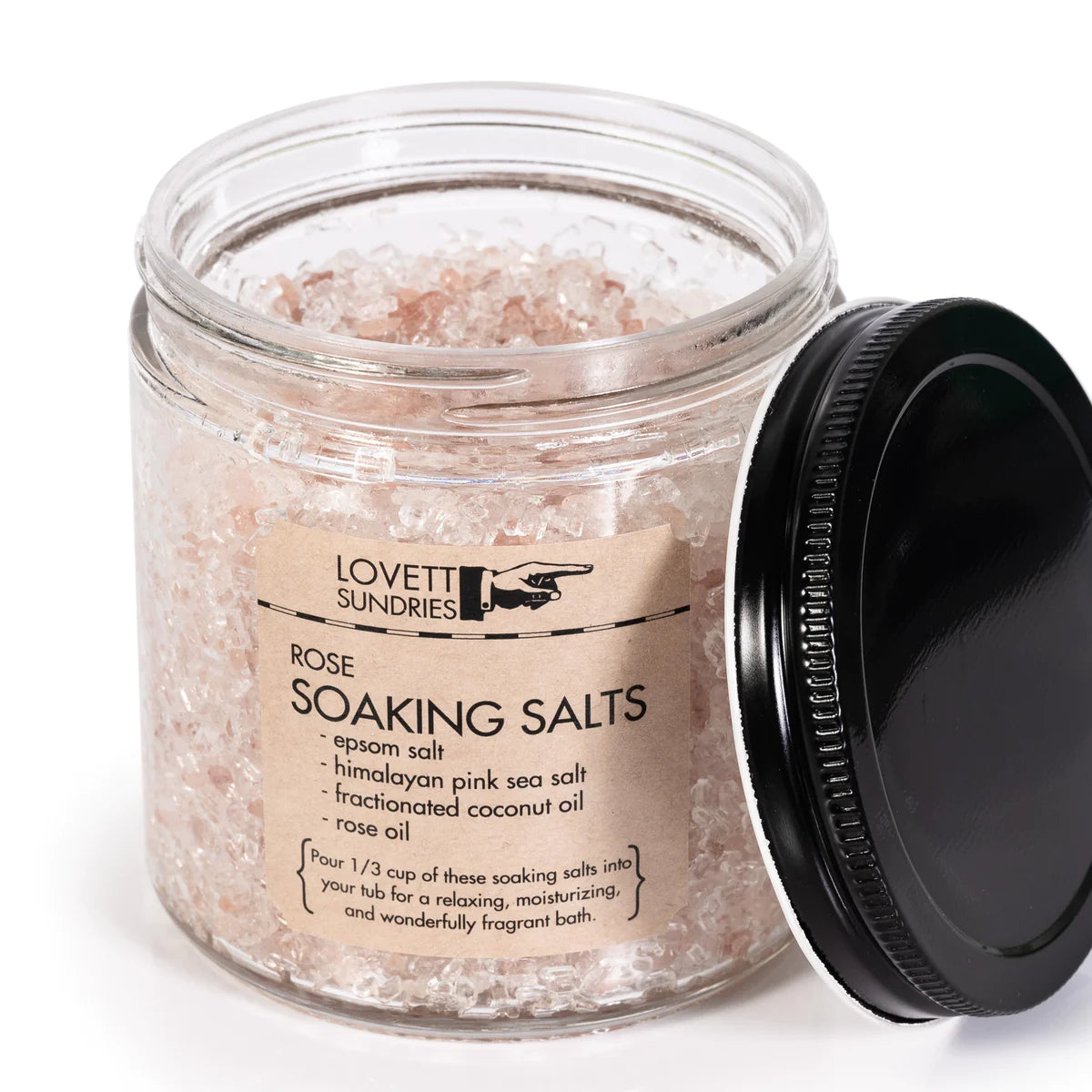 An open glass jar of rose soaking salts by lovett sundries. The salts are pink from the himalayan pink sea salt